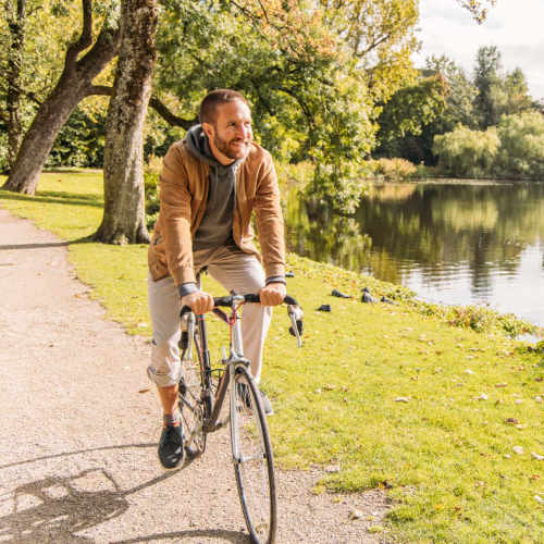 Resident riding a bicycle near Truckee River Terrace in Reno, Nevada