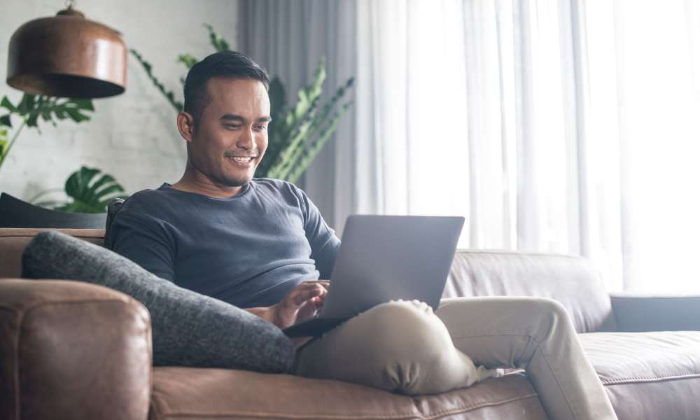 Happy resident checking out our online resources from his new apartment at Crown Villa Apartments in Savannah, Georgia