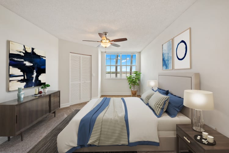 Model bedroom with beautiful view at St. Tropez Apartments in Miami Lakes, Florida