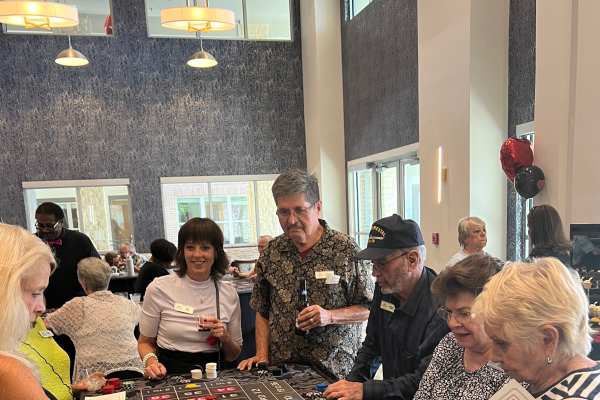 Resident playing bingo at a LifeLoop activity, supporting engagement and cognitive stimulation