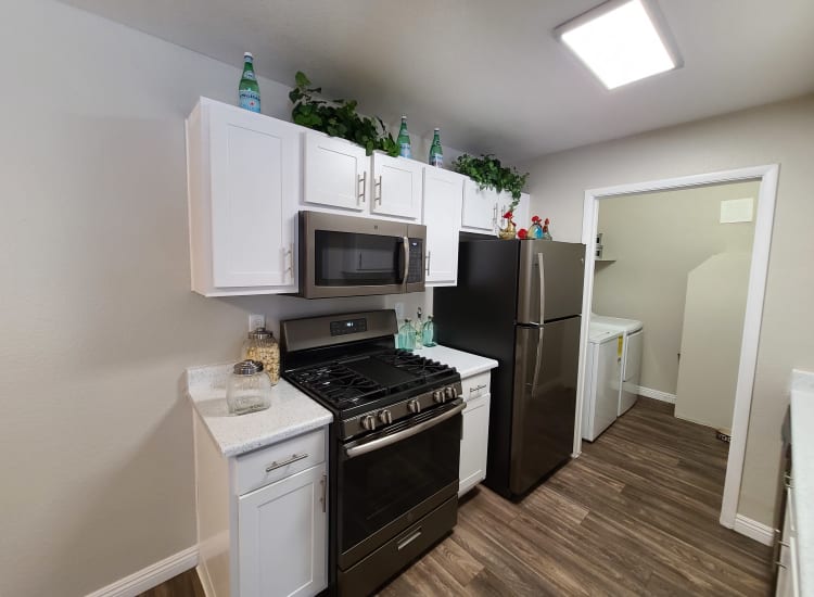 Kitchen with black appliances in a model apartment at Alterra Apartments in Las Vegas, Nevada