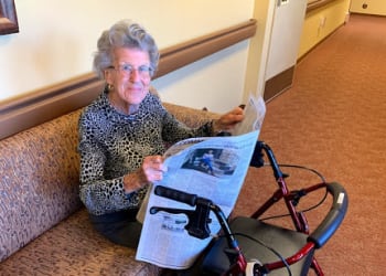 A resident reading the paper at Amber Grove Place in Chico, California. 
