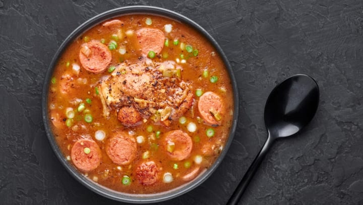 An aerial view of a bowl of chicken and sausage gumbo soup in black bowl on a table at a Brunswick restaurant.