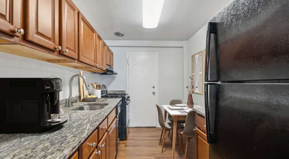 Modern kitchen with wooden cabinets and refrigerator at Georgia West in Silver Spring, Maryland