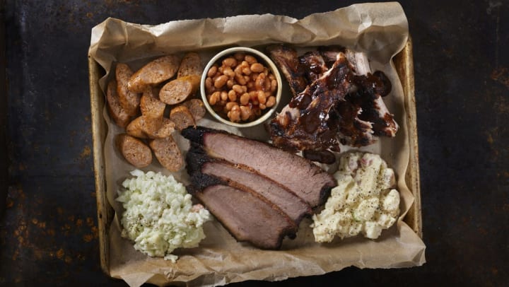 Barbecue platter with brisket, ribs, sausage, beans, coleslaw, and potato salad | bbq restaurants in Brunswick 