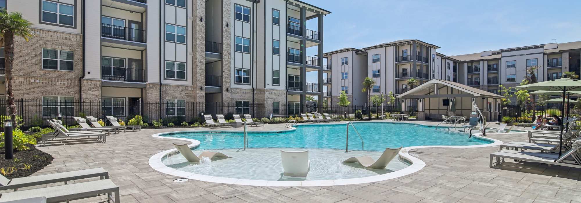 Resort style swimming pool and sundeck lounge chairs at Somerset in McDonough, Georgia
