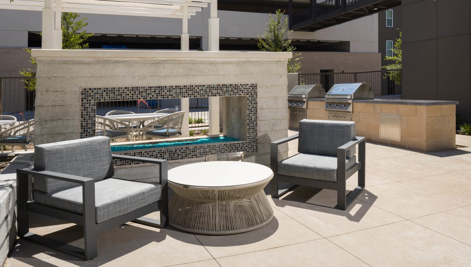Comfortable seating at one of the outdoor common areas at Lux on Main in Carrollton, Texas