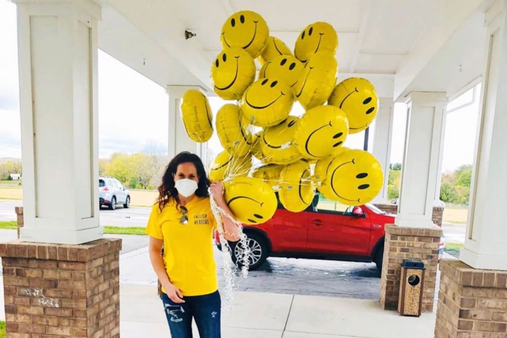 A women wihth smile face balloons at English Meadows Laurens Campus in Laurens, South Carolina 