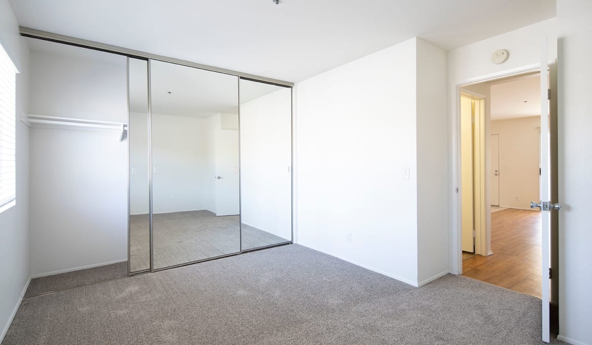 Mirrored closet doors in bedroom at Jackson 23 Apartments in La Mesa, CA