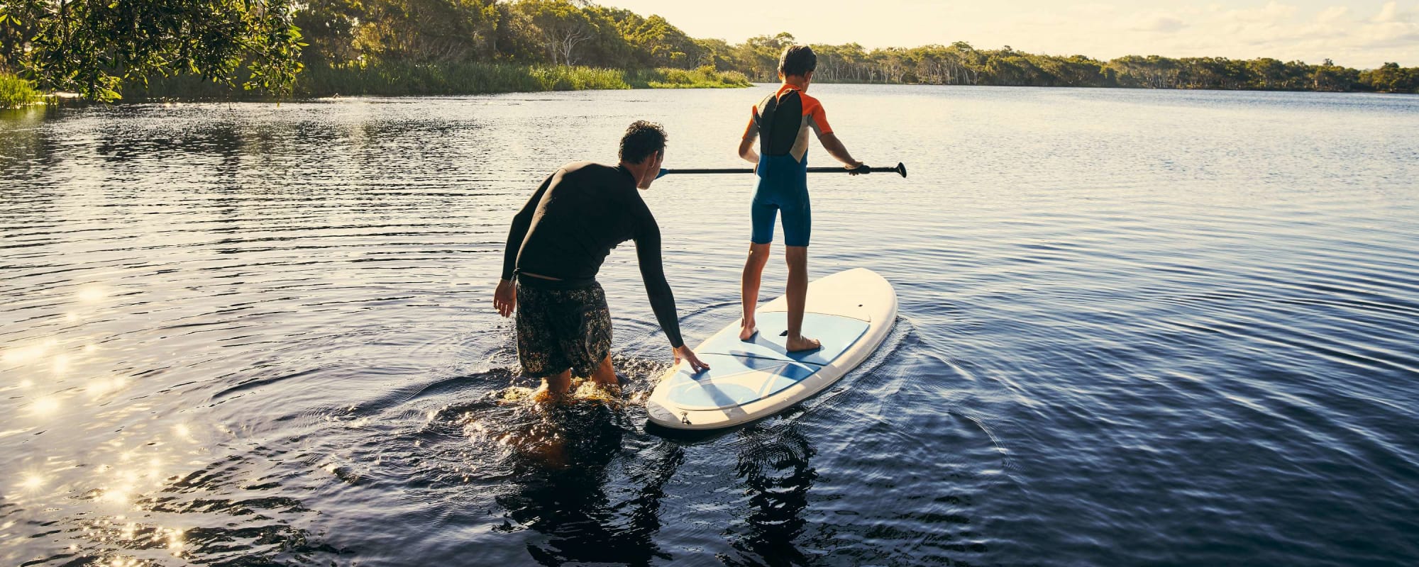 Family paddle boards near The Edge at Clear Lake in Webster, Texas