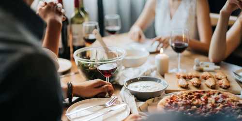 Residents enjoying a pizza feast at their favorite restaurant near Birch Tree Apartments in Lansing, Michigan