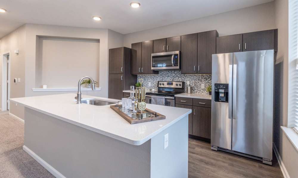 Well-equipped kitchen with refrigerator at Villas On Fir in Granger, Indiana