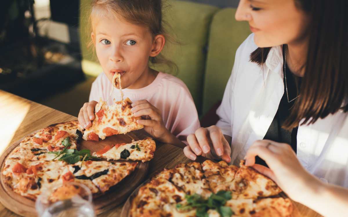 Residents family eating pizza near Meridian Oaks in Tallahassee, Florida