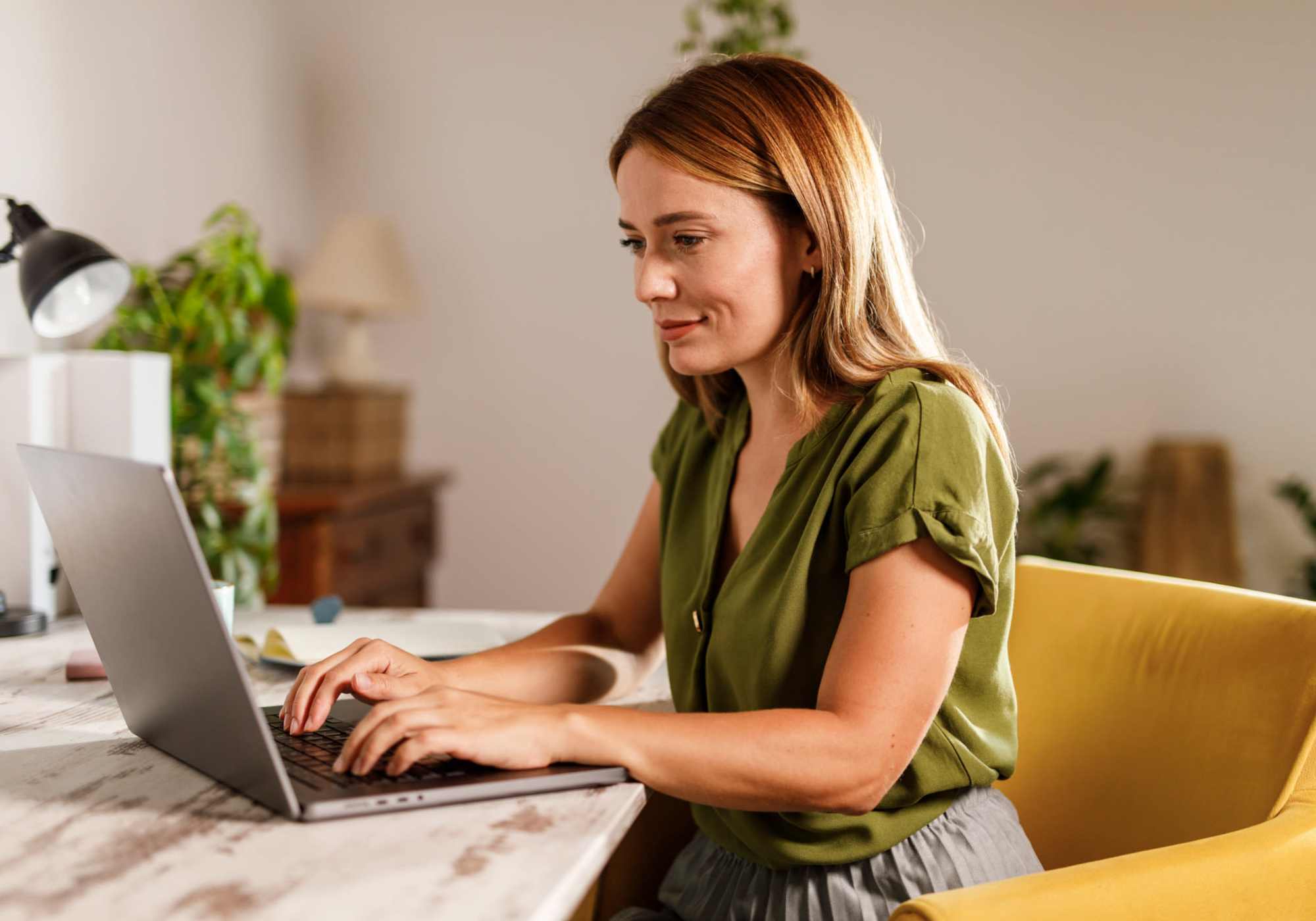Young woman apply for apartment on laptop at Randall Highlands in North Aurora, IL