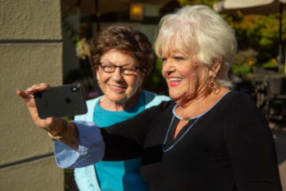 Two residents taking a selfie at Courtyards at Berne Village in New Bern, North Carolina