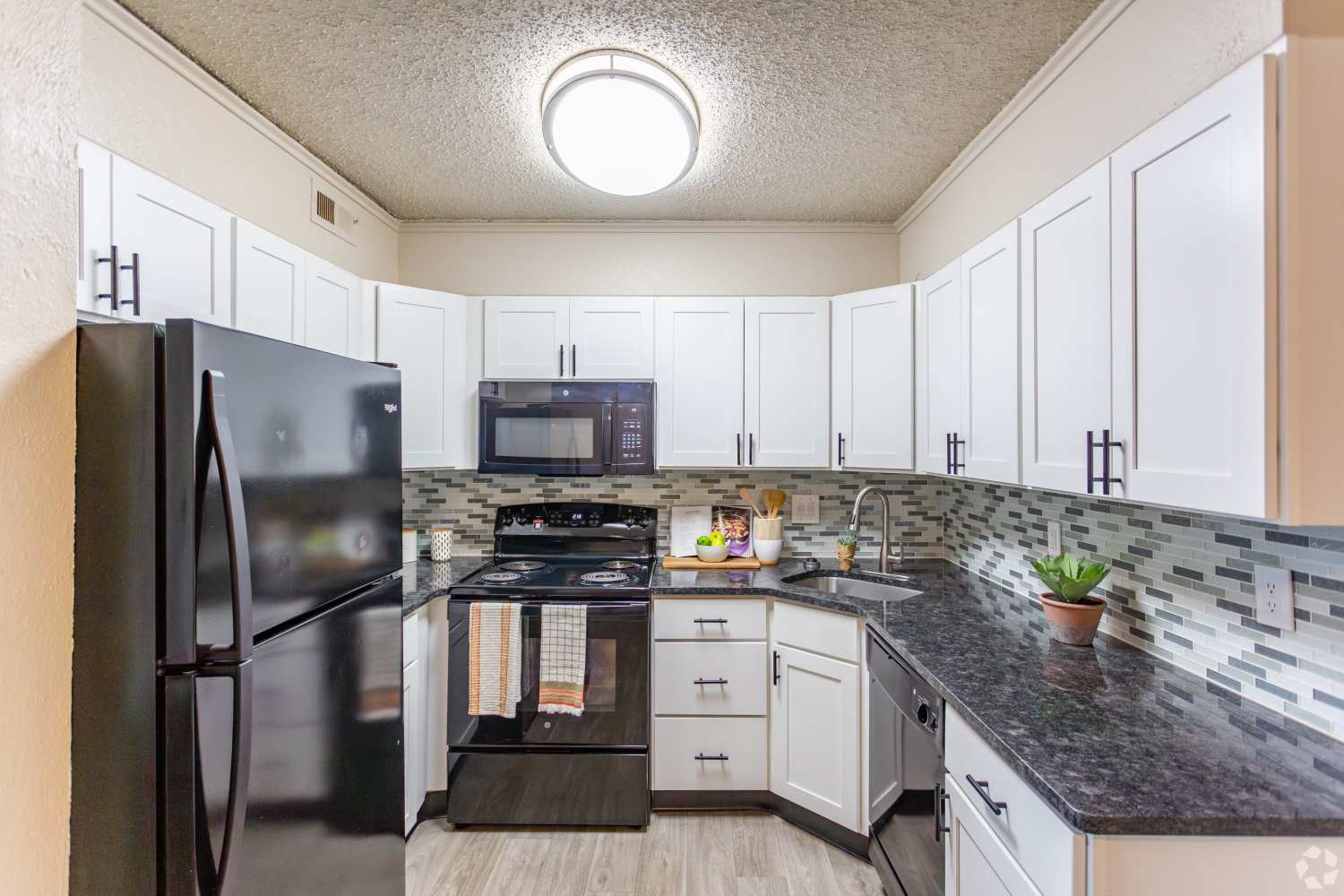 Fully equipped kitchen with white appliances at Sheffield Heights Apartment Homes in Nashville, Tennessee
