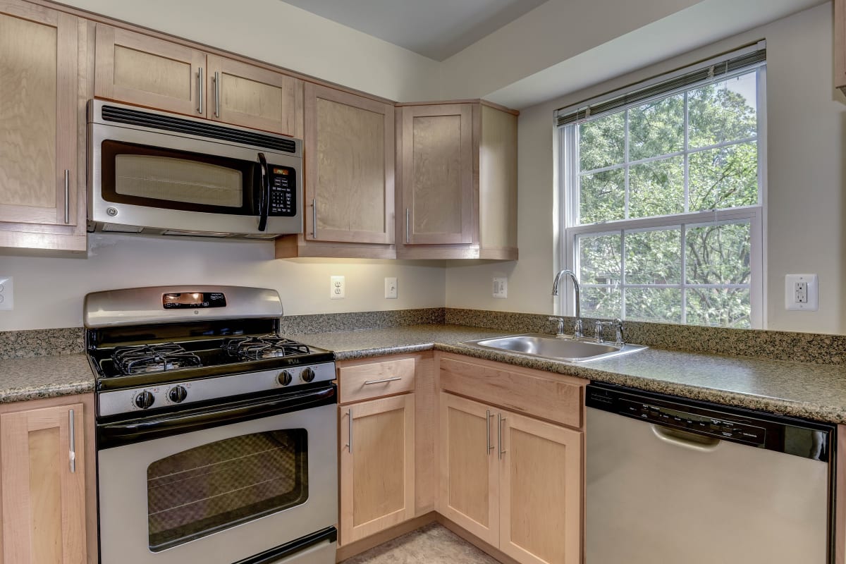 Nice looking light wood cabinets with stainless steel appliance in the kitchen at The Gardens at Del Ray in Alexandria, Virginia
