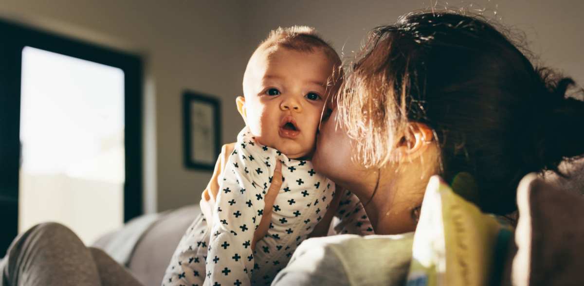 A mother holds her baby in her apartment at Rockwood Park, Richmond, Virginia