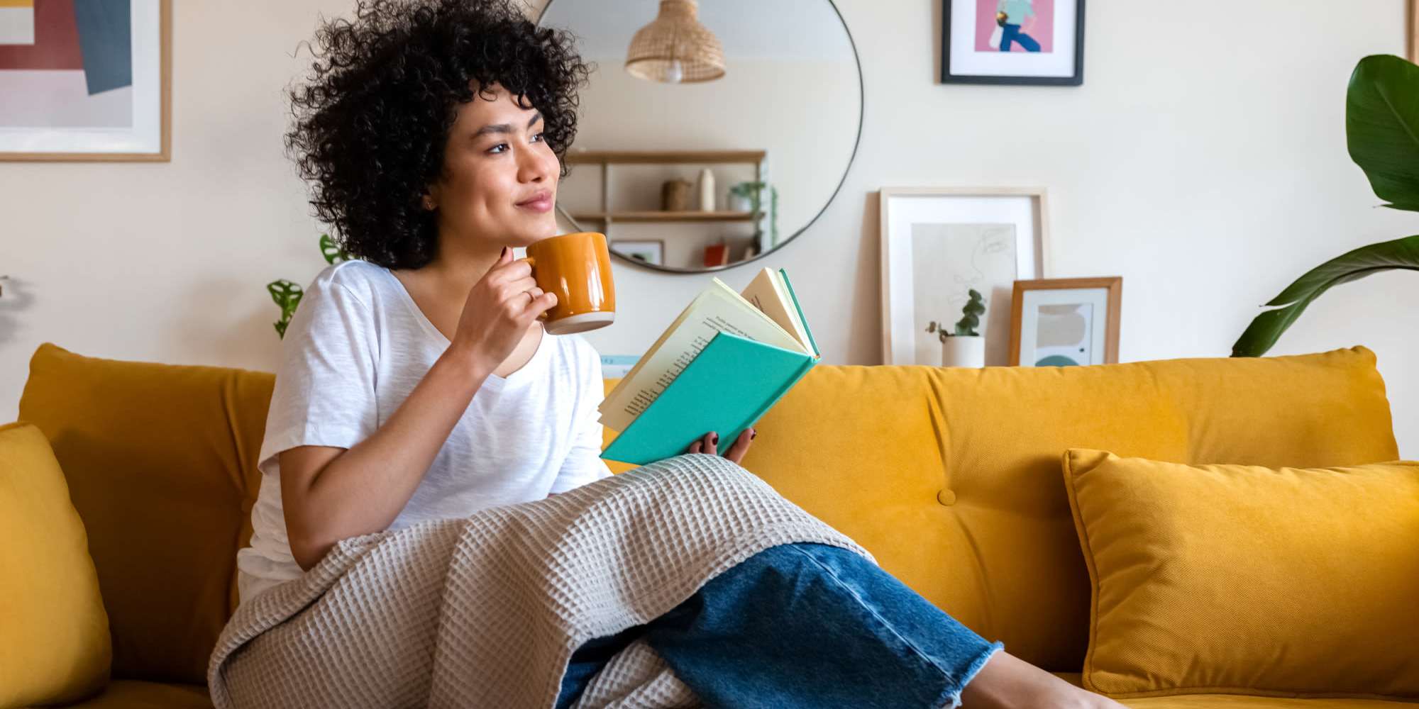 Resident having morning coffee while reading books at Ridgewood at Greenbrier in Greenbrier, Tennessee