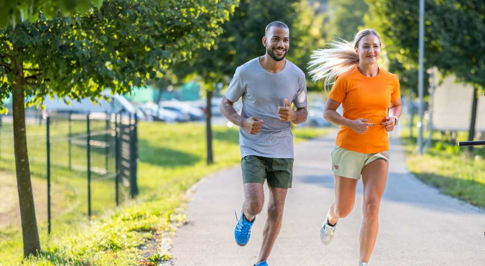 Residents couple jogging in park near The Depot at North Salem in Apex, North Carolina
