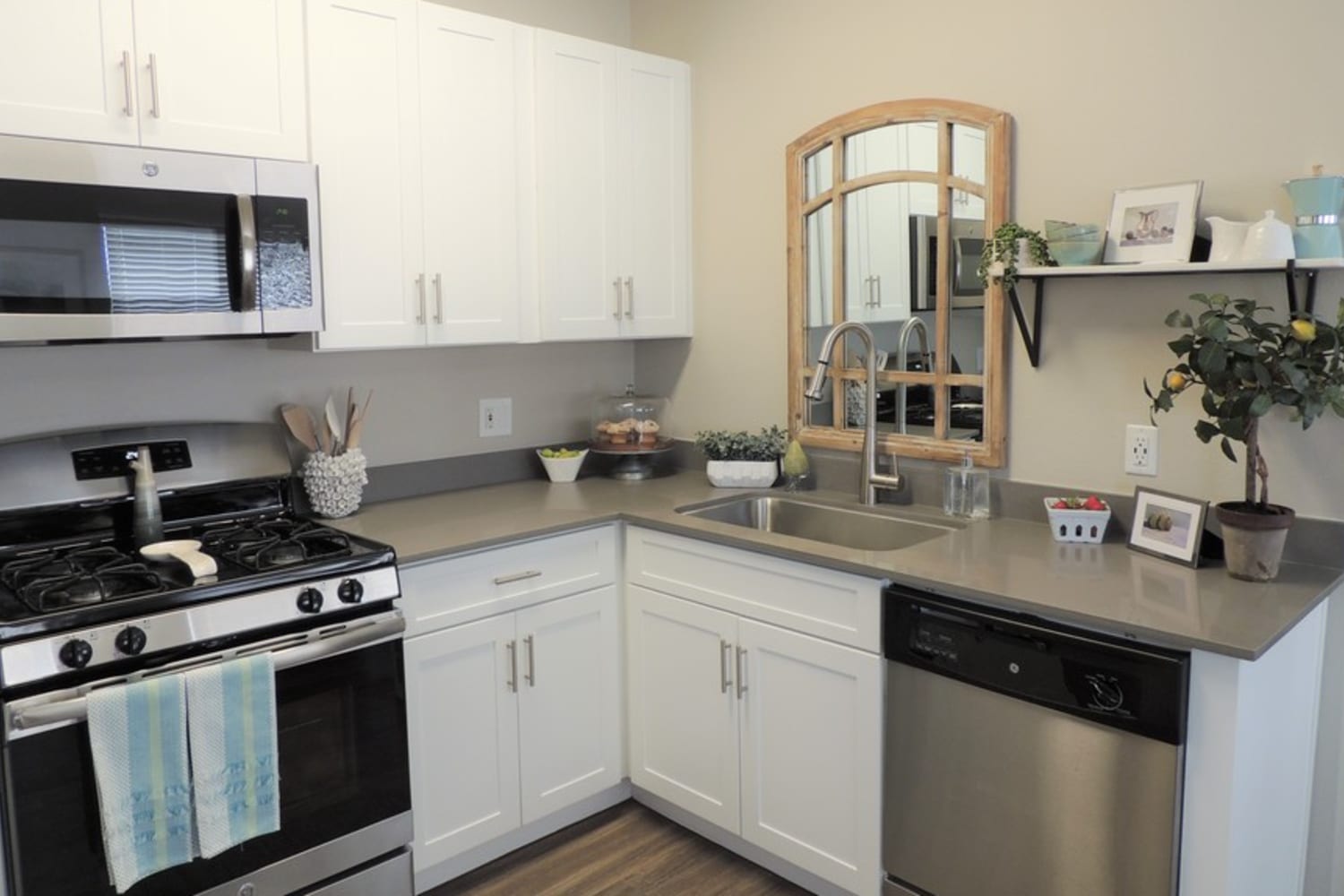 Kitchen with modern appliances and white cabinets at Madrid Apartments in Mission Viejo, California