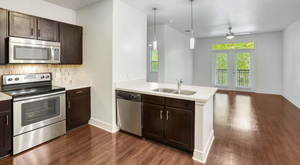 Open layout kitchen with easy access to living room at Trinity Bluff & Trinity District in Fort Worth, Texas