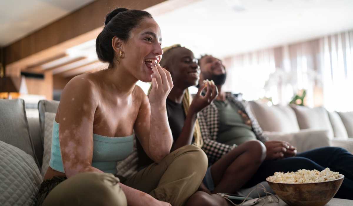 Friends enjoying a movie in the community clubhouse at One West End in Charlotte, North Carolina