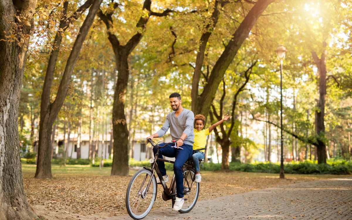 Resident cycling with his daughter near Heather Hill Apartments in Temple Hills, Maryland  