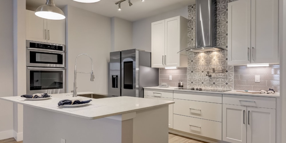 A modern kitchen with tiled backsplash at Addison Square in Viera, Florida