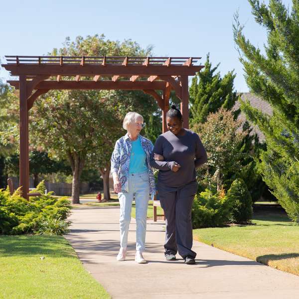 Resident walking with team member.