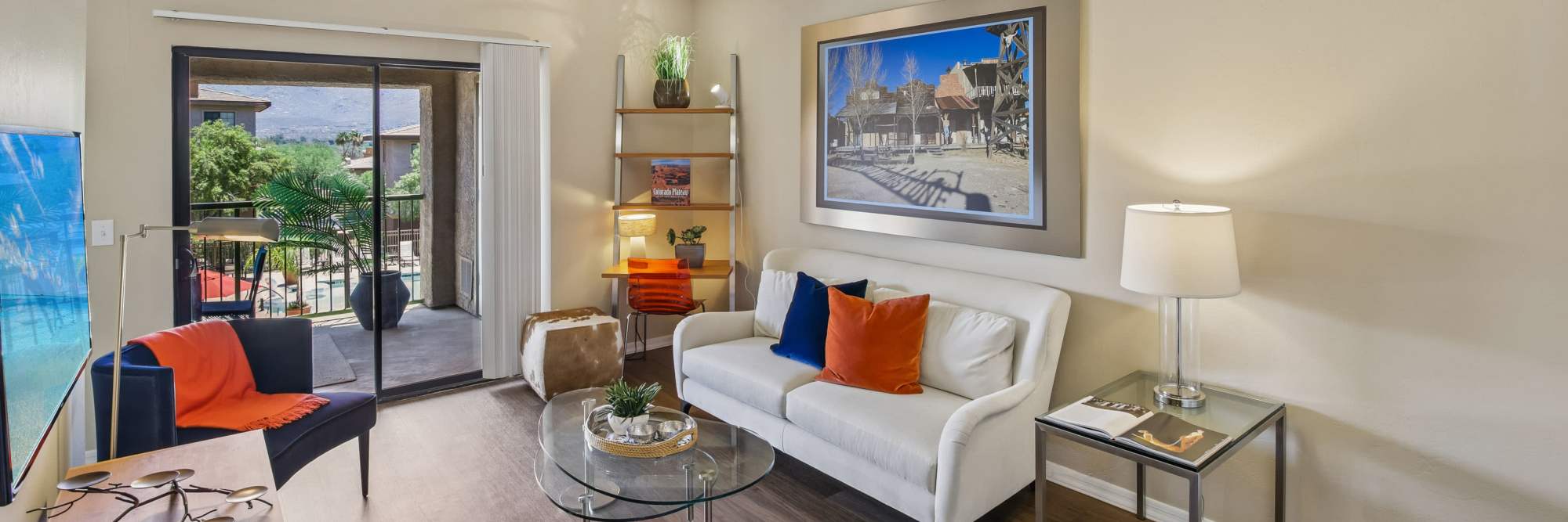 Cozy apartment living room with balcony access at Oro Vista Apartments in Oro Valley, Arizona