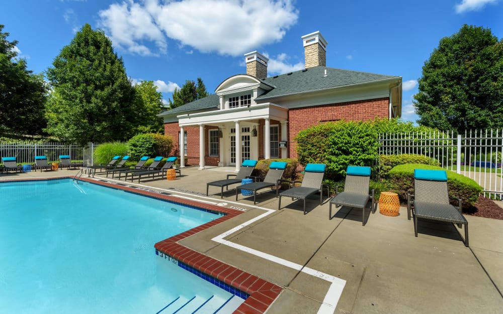 Swimming pool and sunny lounge chairs at Christopher Wren Apartments & Townhomes in Wexford, Pennsylvania