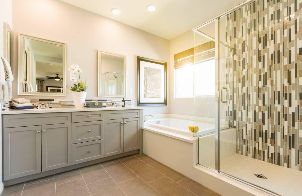 A modern apartment bathroom with a large tub in an apartment at Mariposa at Clear Creek in Webster, Texas