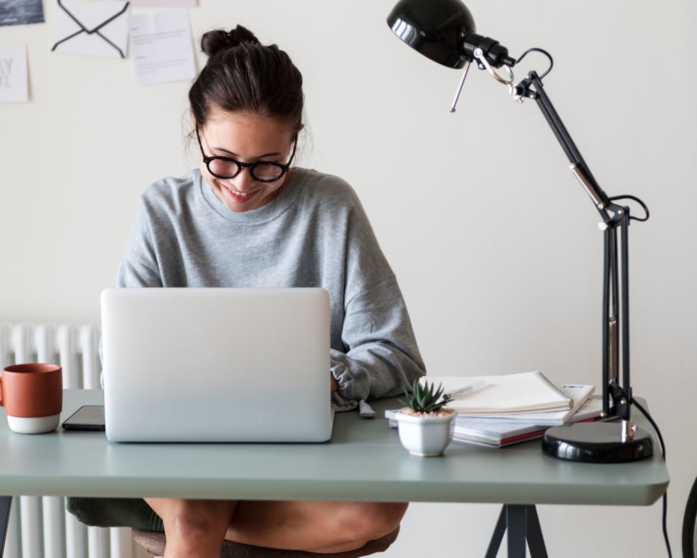 Resident working at her home desk at Sofi Ocean Hills in Oceanside, California