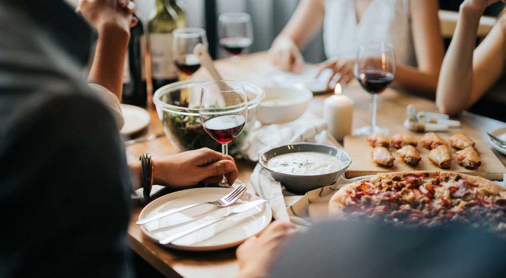 Residents having delicious food at a restaurant near McCart Apartment Homes in Fort Worth, Texas