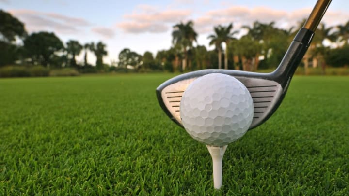 a golf ball and club at a Jacksonville golf course