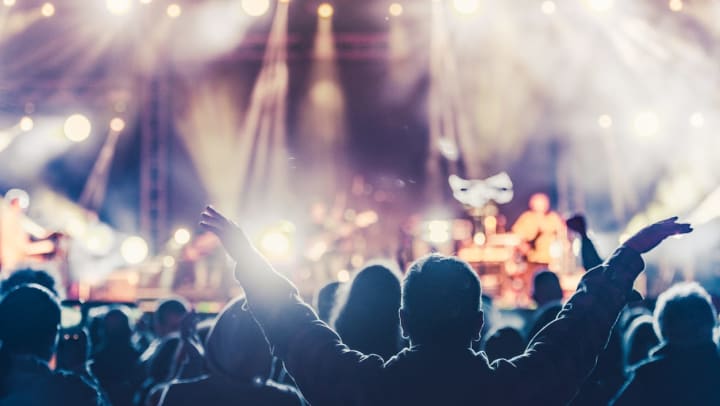 A large crowd in front of a stage at a concert venue in Odessa.