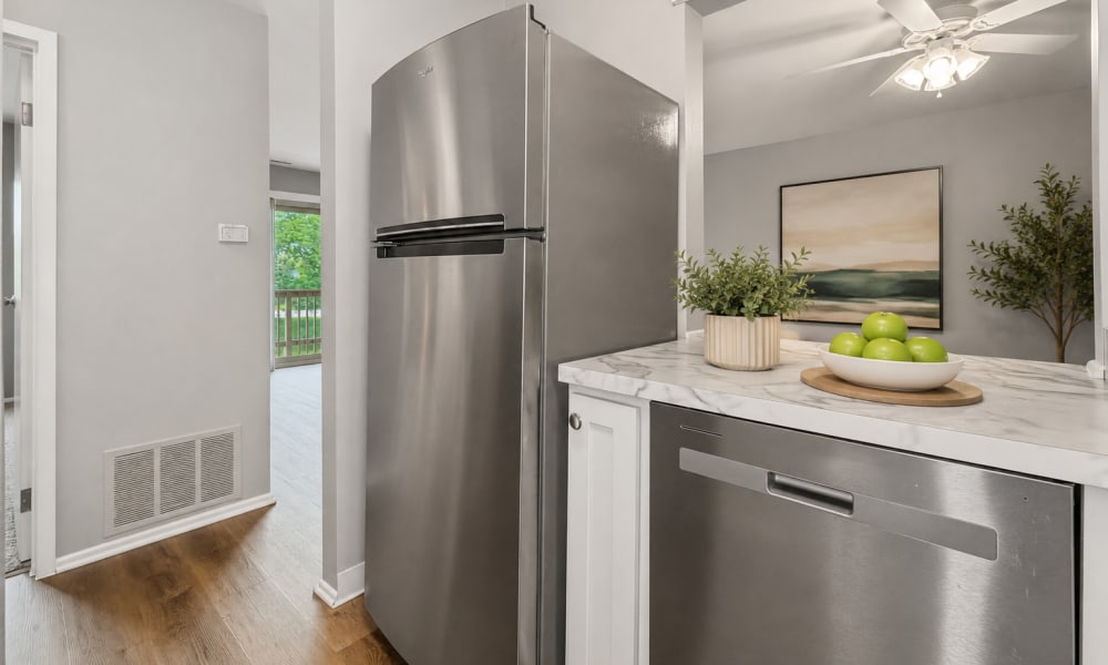 Kitchen with steel appliances and wooden flooring at Edenbridge Apartments in Tinley Park, Illinois