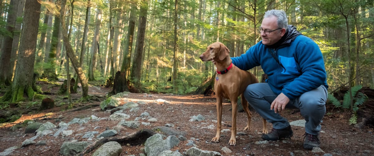 Man out on a hike with his dog at The Met Rockville in Rockville, Maryland