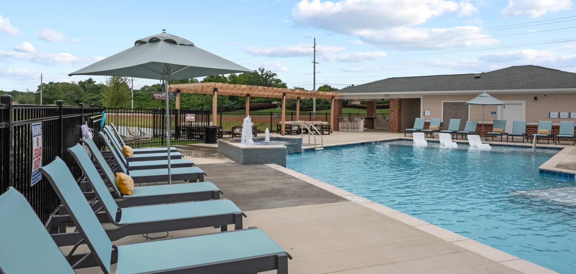 Outdoor pool area with lounge chairs at Attain at Bradford Creek apartments in Huntsville Alabama