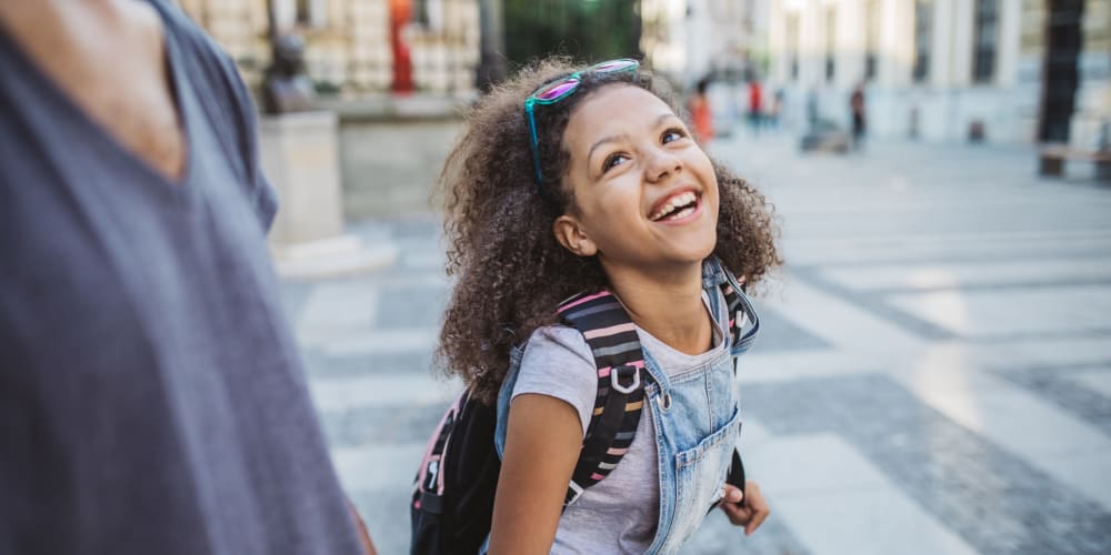 Girl walking to school near alttext