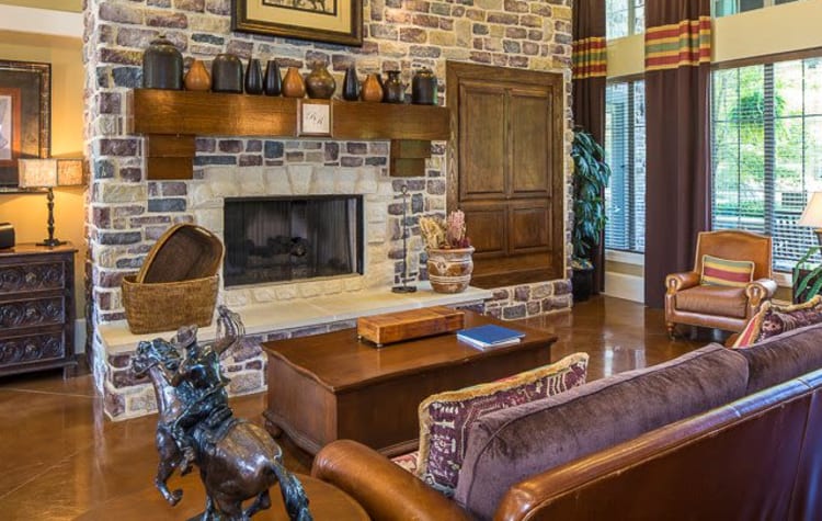 Rustic clubhouse with a large fireplace and plenty of seating for entertaining guest at Ranch ThreeOFive in Arlington, Texas