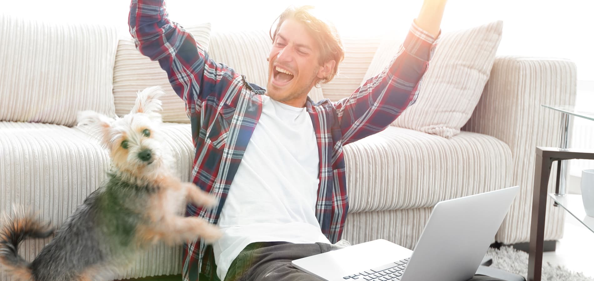 Happy resident with dog on couch at Callio Properties