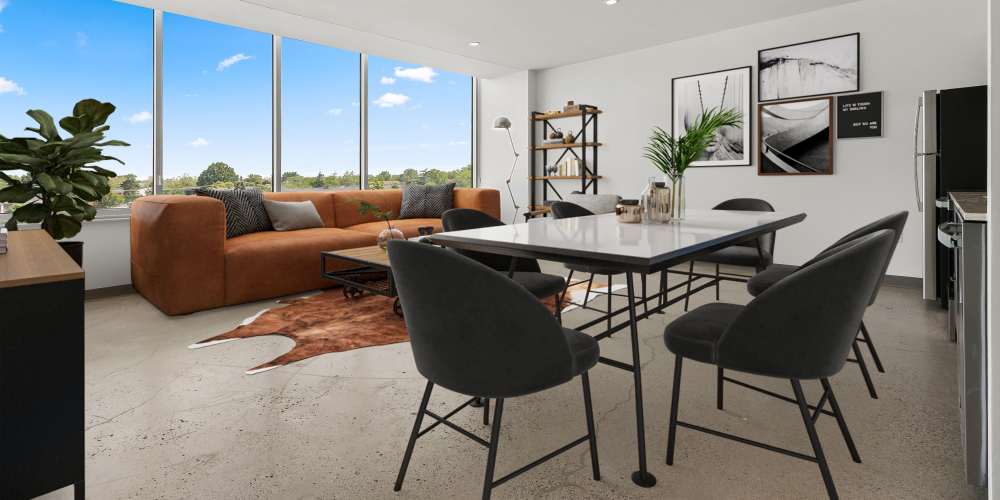 Contemporary living area adjacent to the dining area at The Bank Tower in Southgate, Michigan