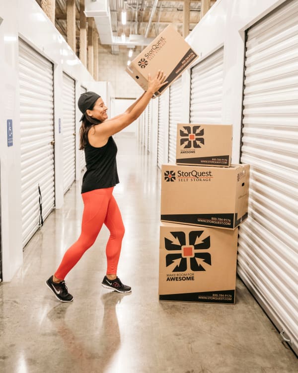 Woman walking with a box at StorQuest Express Self Service Storage