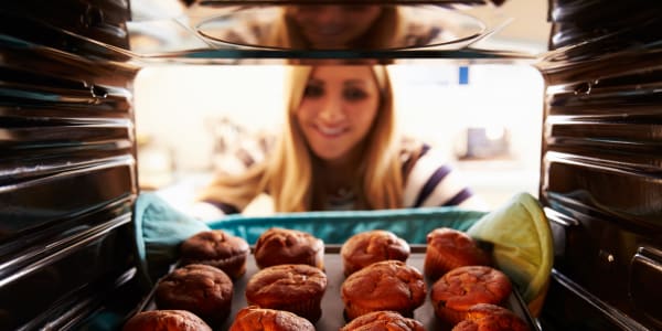 Caretaker puling muffins out of the oven at Ingleside Communities in Mount Horeb, Wisconsin