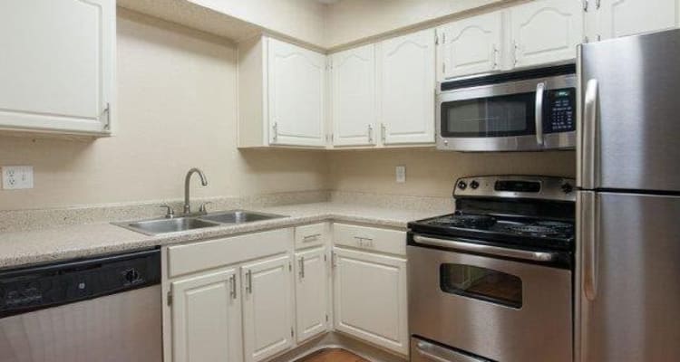 Kitchen with plenty of counter space and stainless-steel appliances at The Regent in Dallas, Texas