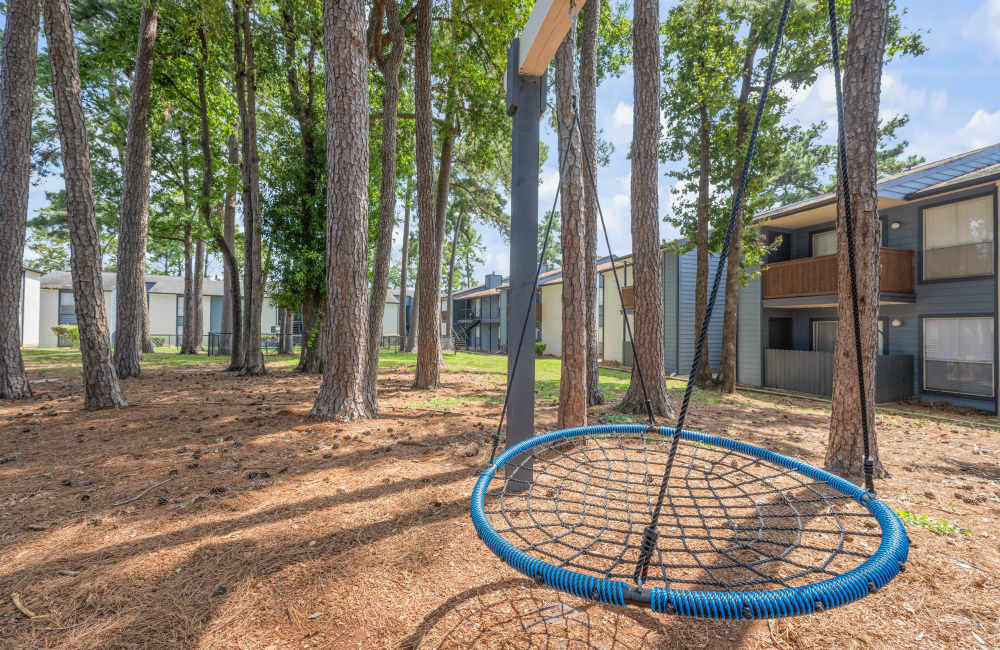 Garden area with full of trees and a swing at Northside Heights in Conroe, Texas
