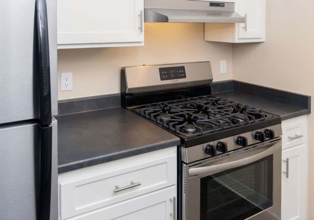 Well-furnished kitchen with wooden cabinets at Amber Court in Fremont, California