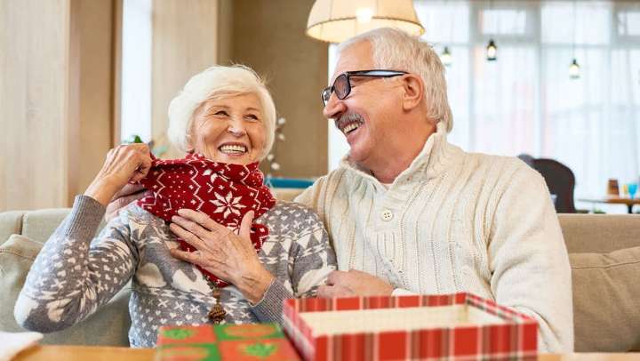 Couple opening gifts for each other at {{location_name}} in {{location_city}}, {{location_state_name}}